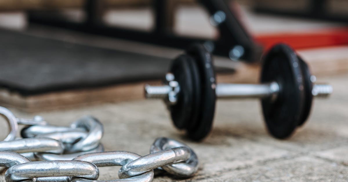 What are these metallic plates found around Iceland? - Metal chain and dumbbell on tiled pavement