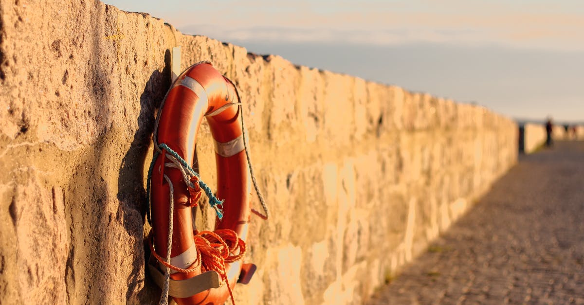 What are these "stone walls" in the sea on Cyprus? - Orange Lifebuoy Hanged on Brown Wall