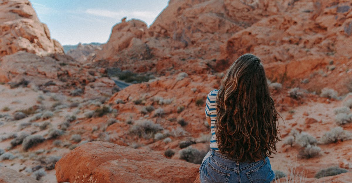 What are these things in the desert near Fallon, Nevada? - Woman in Blue Denim Shorts Sitting on Brown Rock Mountain