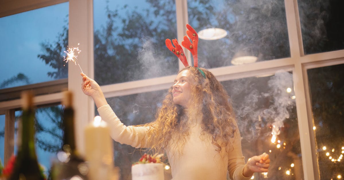 What can Thomas Cook customers (who have not yet departed) do now they have stopped operating? - Content female chef in decorative deer horns with shiny sparkler celebrating New Year holiday while looking away in house