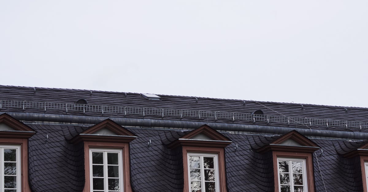 What city is this? [closed] - Close-up of a Windows in the Roof of a Tenement House