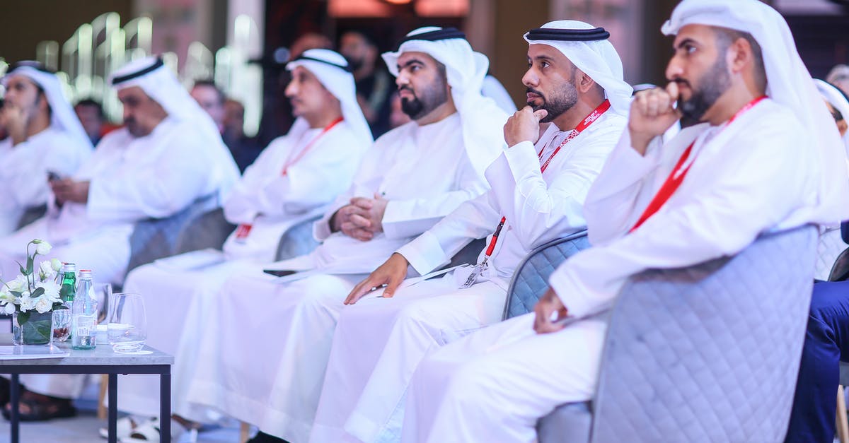 What clothing should I bring to Dubai during February? - People in Traditional Clothing in a Conference