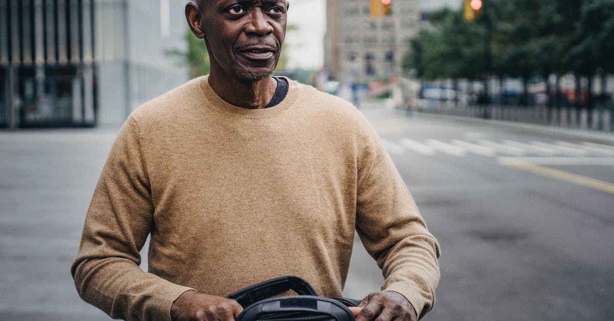 What do the passport stamps for Guernsey and Jersey look like? - Focused black businessman with personal bag in downtown