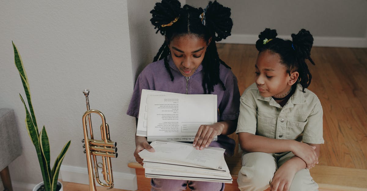 What documents are needed to take a child to the UK? - Sisters Looking at Papers Together While Sitting on the Floor