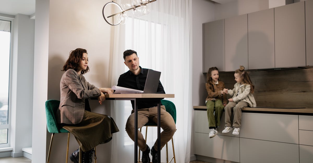 What documents are needed to take a child to the UK? - 
A Couple Looking at Documents while Their Daughters are Sitting on a Kitchen Counter