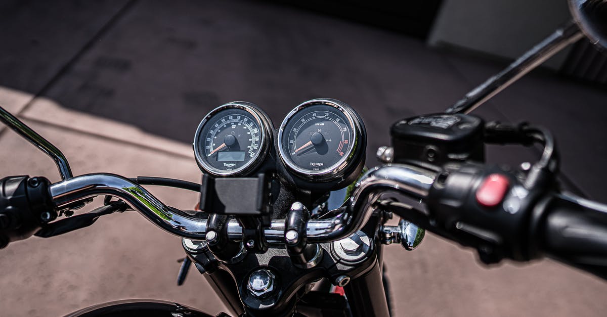 What documents are required to drive a motorcycle from Kazakhstan to China? - Motorcycle control panel with speedometer in daylight