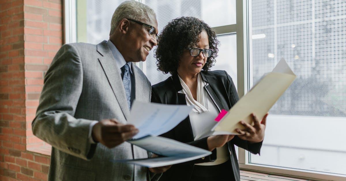 What documents do I need to obtain South African visa? - A Man and Woman Having Conversation while Standing Near the Window