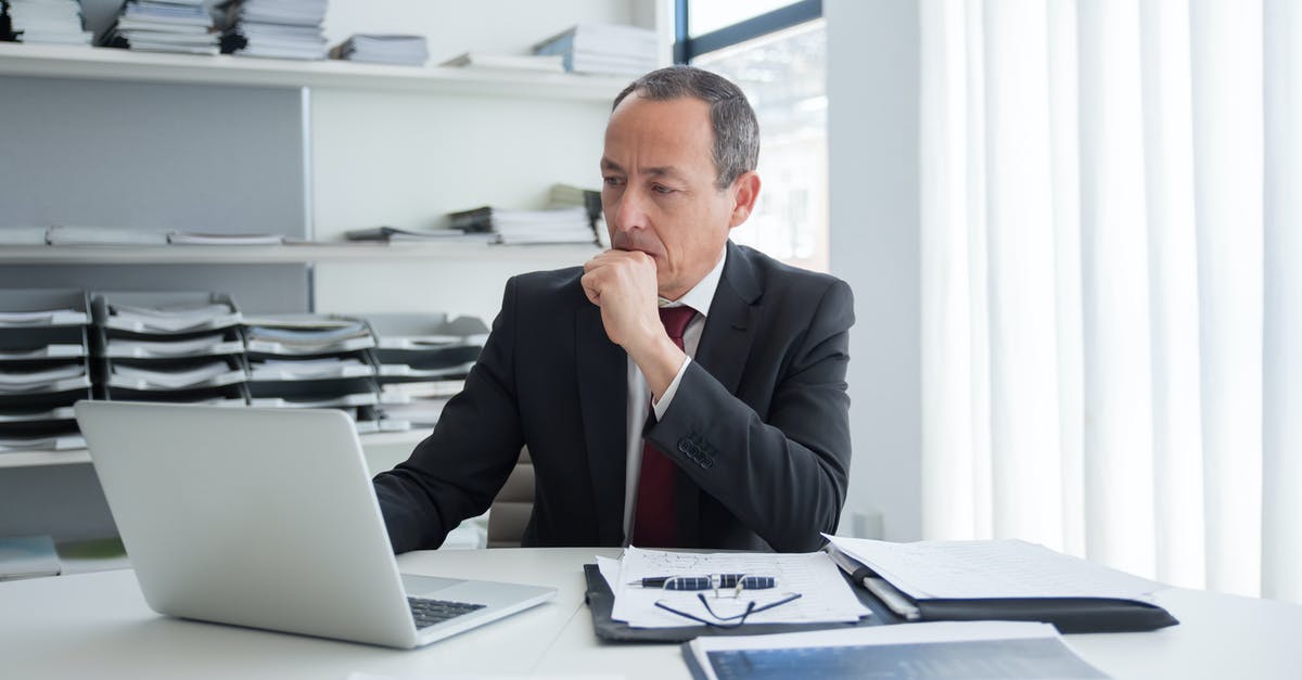 What documents should I submit after refusal of a visit visa? - Pensive Man Sitting Behind His Desk Using Laptop