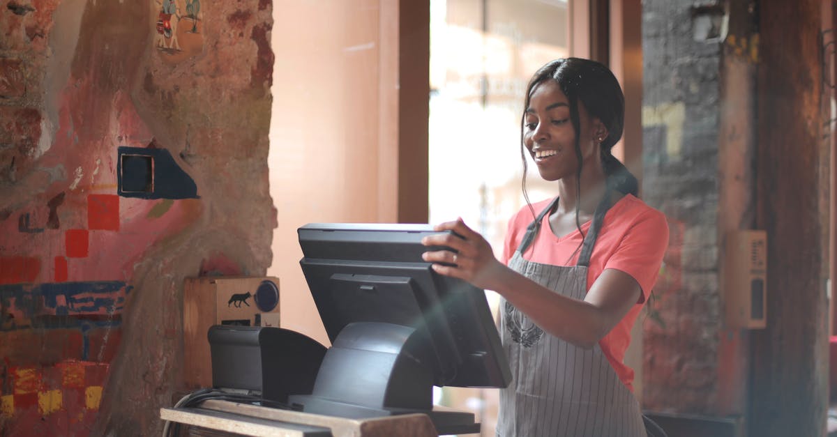 What does i.i stand for in a menu in Costa Rica - Cheerful American African waitress in apron working on counter monitor while registering order at cozy cafe