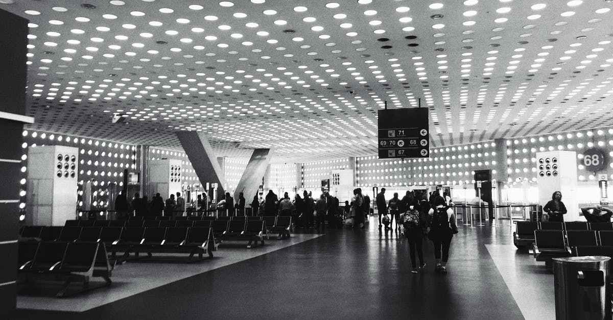 What does it mean by airport immigration area? - Grayscale Photography of People Walking on Concrete Pavement Hallway