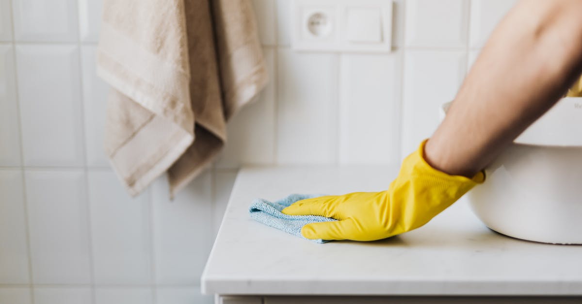 What does the TSA consider to be household cleaners? - Crop housewife cleaning surface near sink