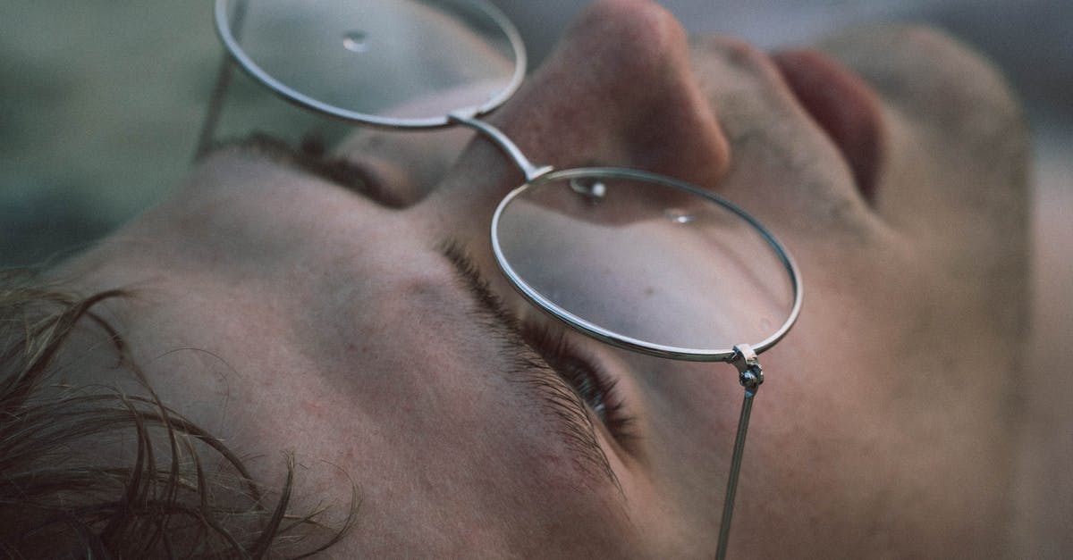 What does the UK immigration form IS 116 look like? - Closeup of crop young male in eyewear with pure water drips looking up on blurred background