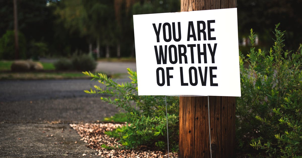 What does this British road sign mean? - You Are Worthy of Love Signage on Brown Wooden Post Taken