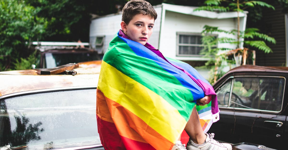 What exactly is covered with this Icelandic car rental? [closed] - A Person with a Rainbow Flag Sitting on the Decklid of a Car