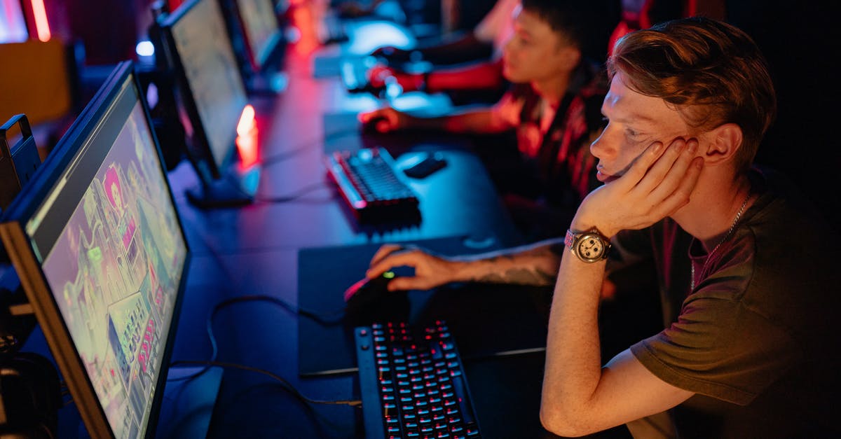 What game did I see in Verona, Italy? - Man in Black T-shirt Using Computer