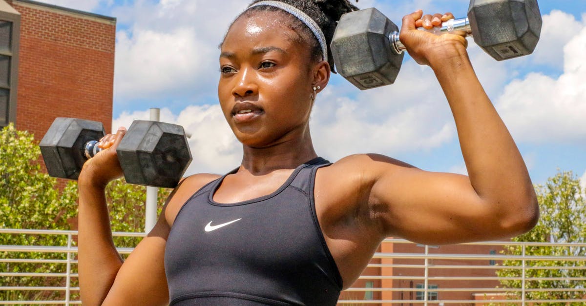 What happened to lifting the liquids ban? - A Woman in Black Sports Bra Lifting Dumbbells