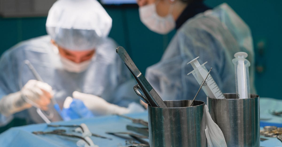 What happens if a tourist needs a medical surgery in U.S.? - Person in White and Green Shirt Holding Silver Cup