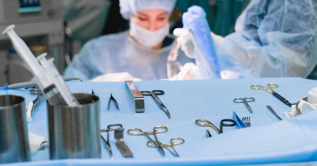 What happens if a tourist needs a medical surgery in U.S.? - Surgical Equipment and Surgeon Performing Surgery 