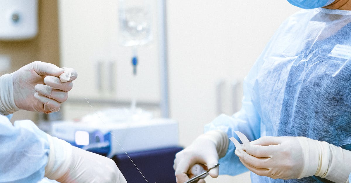 What happens if a tourist needs a medical surgery in U.S.? - Photo of Medical Professionals Wearing Personal Protective Equipment