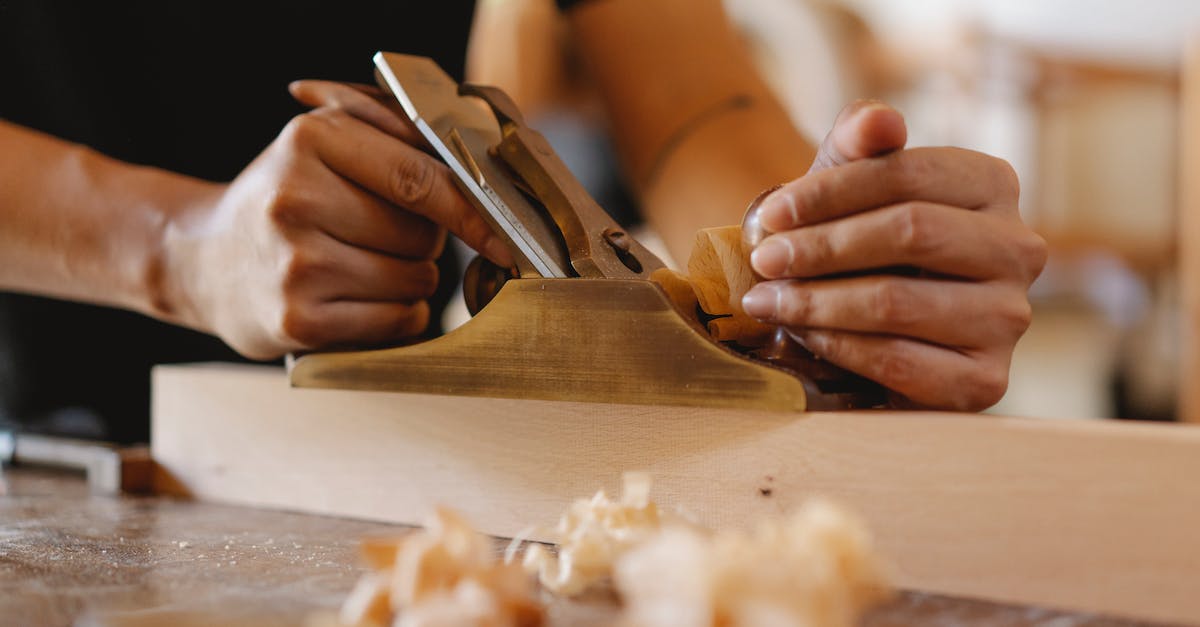 What happens if someone dies on board a plane? - Crop man shaping wood with hand plane in workshop