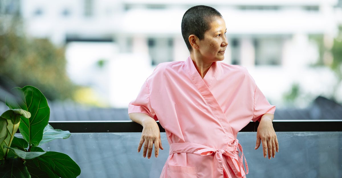 What happens if you become seriously ill during a flight? - Asian women in patient robe standing on terrace in sunny day