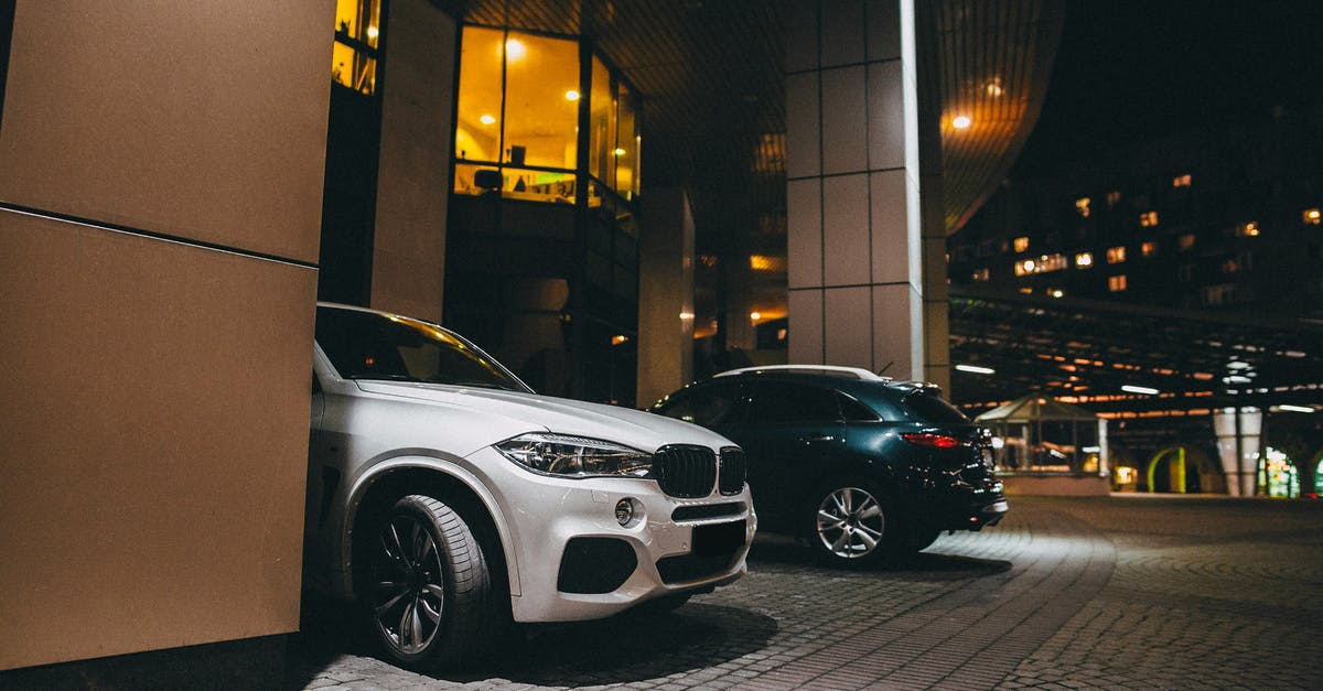 What is a "penalty for a driving offence?" - White Mercedes Benz C Class Parked Near Black and White Building during Night Time