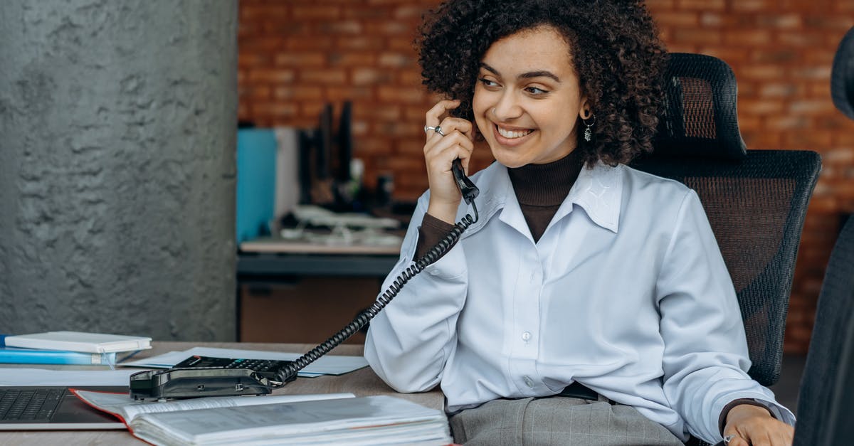 What is the AXA Schengen Insurance office phone number? - Woman in White Dress Shirt Sitting on Chair