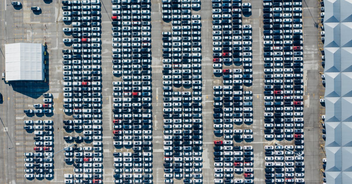 What is the cheapest way, by public transport, of getting from Tournai to Lille airport? - Aerial view of various modern vehicles parked in row on street near modern building on sunny day What is the cheapest way, by public transport, of getting from Tournai to Lille airport? - Aerial view of various modern vehicles parked in row on street near modern building on sunny day