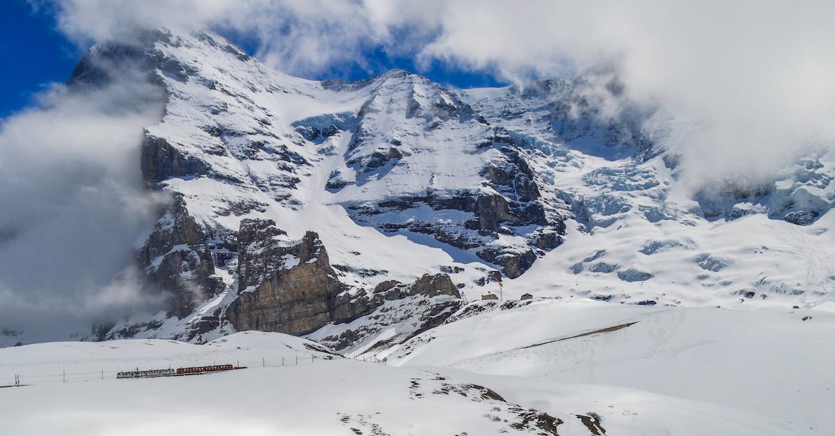 What is the cheapest way to see snow from Singapore? - Mountainside covered in snow in clouds