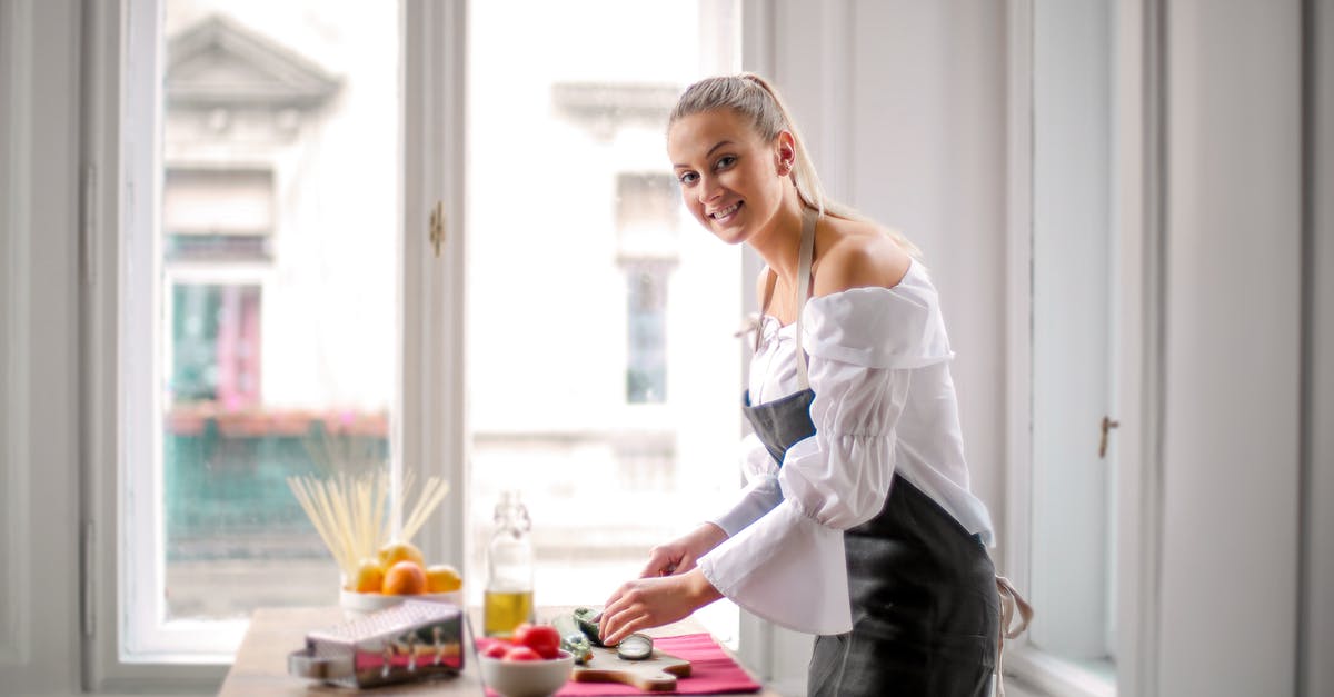 What is the dress code for the Vienna State Opera (Standing Room Section)? - Woman in White and Black Off Shoulder Dress Standing Bedide Wooden Table