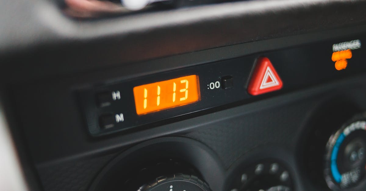 What is the driving time in a car from Zamyn-Uud to Ulaanbaatar? - Electronic clock on dashboard of car