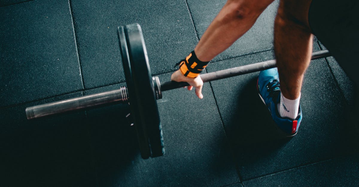 What is the easyjet hand luggage weight limit? - Person Wearing Black Shorts and Blue Lace-up Low-top Sneaker Holding Black Barbell