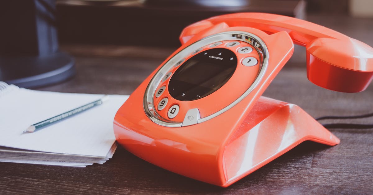 What is the French phone number for medical emergencies? - Red Cradle Telephone on Brown Wooden Surface