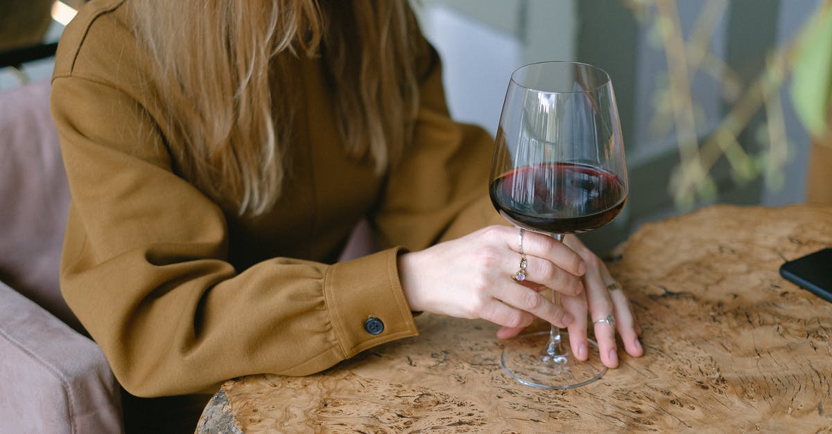 What is the largest pub/bar in Europe? - Close-up of Woman Sitting at Table Drinking Wine