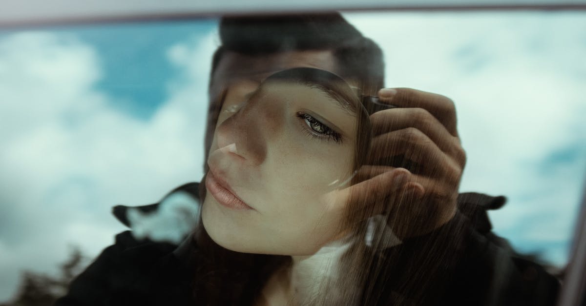 What is the longest distance by car ferry? - Unrecognizable man taking photo of pensive young female sitting in car and looking through window