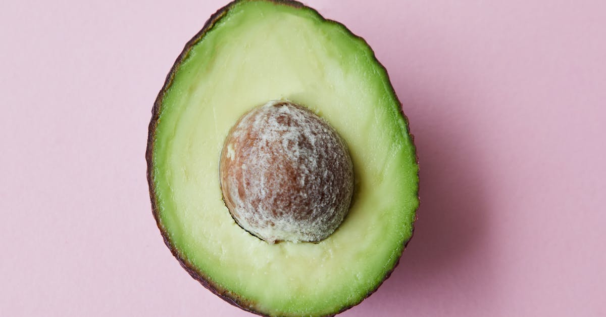 What is the most affordable tropical getaway from Seattle? [closed] - From above of half of fresh raw ripe avocado with seed on purple background