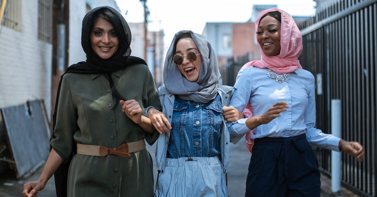 What is the most beautiful and pleasant city for a citytrip? Vienna or Budapest? [closed] - Joyful multiethnic women in headscarves walking on street