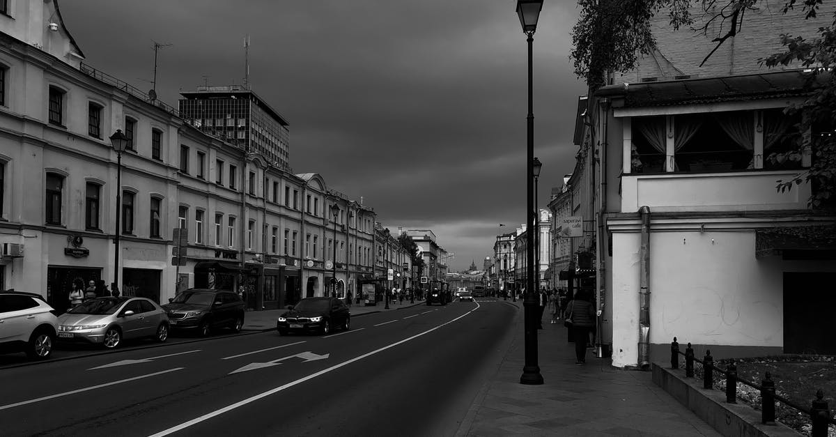 What is the most inexpensive way to obtain a visa for Russia and stay legally for 30 days? - Vehicles parked on city street near old buildings on cloudy day