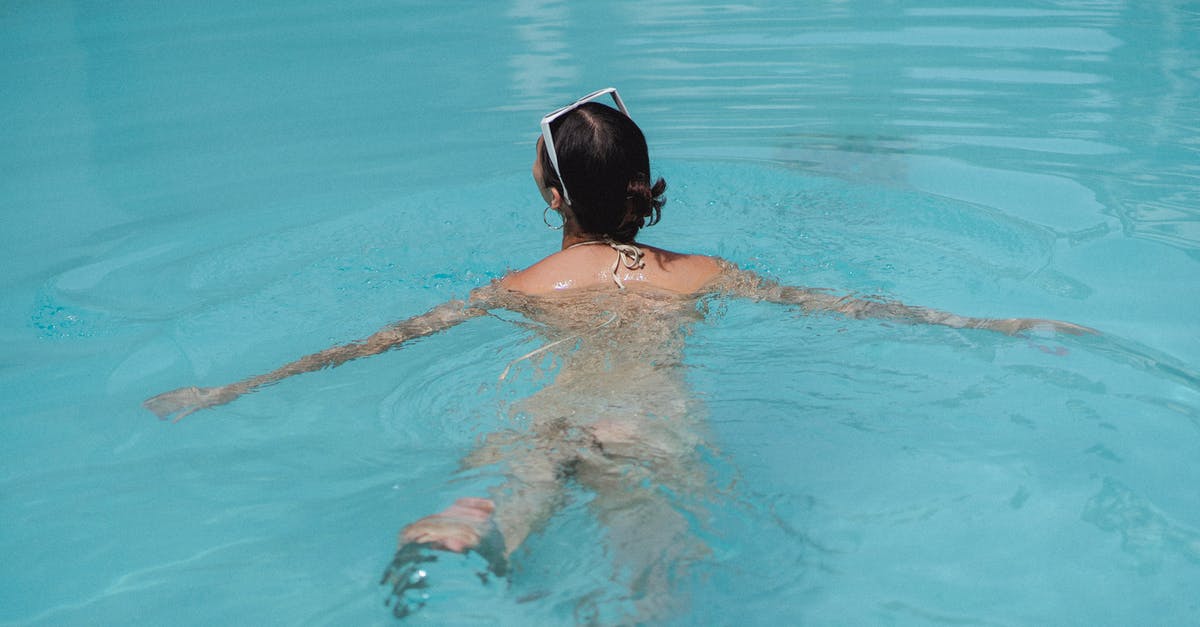 What is the nearest underwater hotel to Germany? - Anonymous female tourist swimming in pool during summer holidays