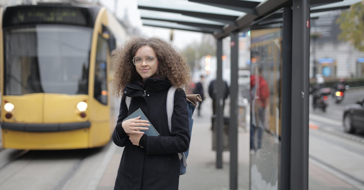 What is the Tanger GR bus terminal destination? - Girl in Black Coat Standing Near Yellow Bus