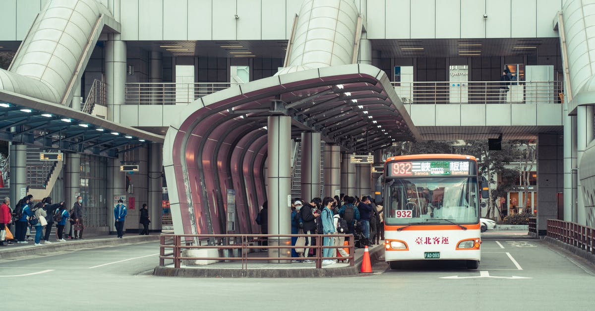 What is the Tanger GR bus terminal destination? - People Standing at a Bus Station