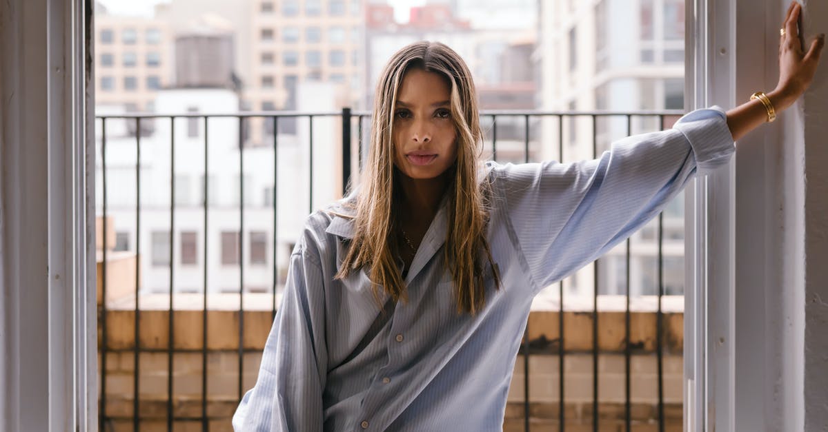 What is this building? - Woman in Gray Long Sleeve Shirt Standing Beside Window