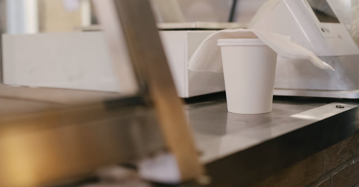 What is this machine inside a terminal in Riga airport? - Side view of ethnic male wearing casual clothes standing near showcase and cash register while buying food in grocery store