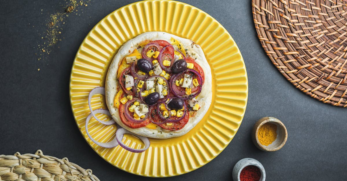 What is this sweet, thick, soy-sauce-like condiment in China? - Flat lay of pizza made of thick dough with vegetables and cheese served in plate near jars with condiment and wicker dishes