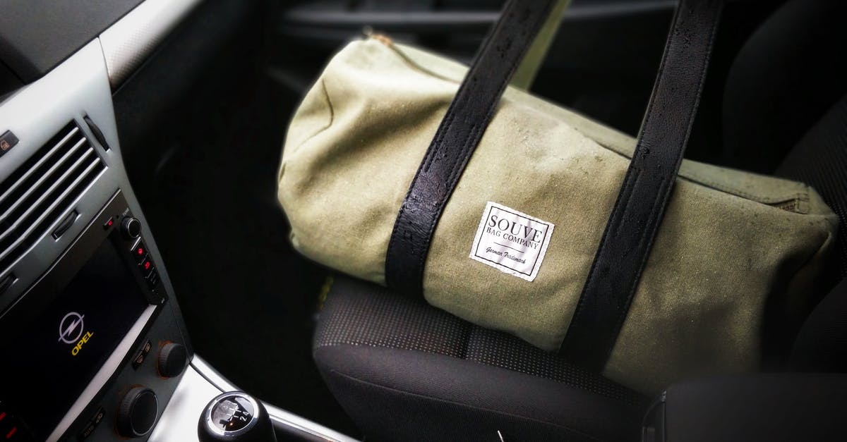 What kind of bag can I use to travel with a baby car seat? - Brown and Black Duffel Bag on a Car Seat