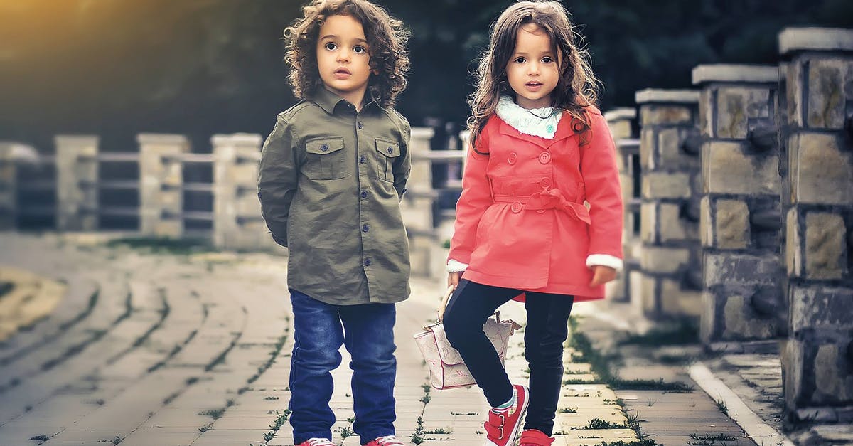 What kind of clothes and footwear are ideal to visit Egypt? - Two Children Standing Near Concrete Fence