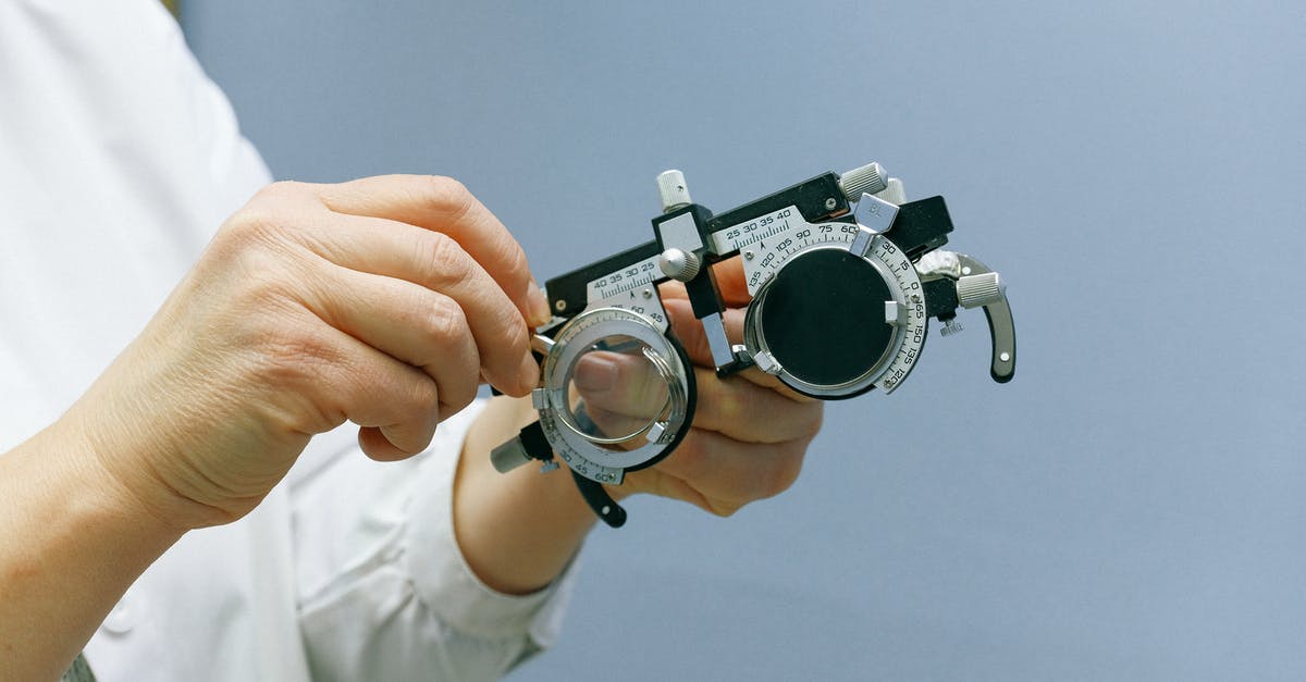 What measures to take in Scotland on unclear 2-day PCR test - Crop anonymous medic showing ophthalmic device