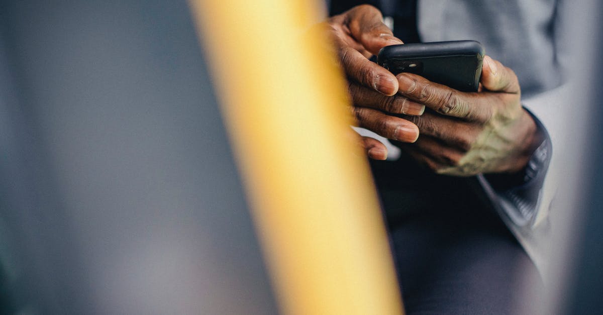 What mobile taxi app can I use in Kutaisi Georgia? - Crop anonymous male in formal clothes sitting in car and browsing modern mobile phone