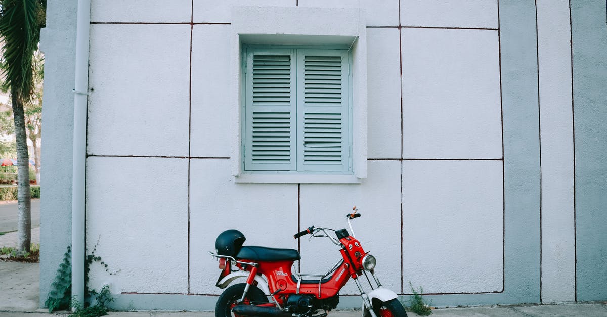 What motorbike to use in Vietnam - Red Motor Scooter Parked Beside White Concrete Building