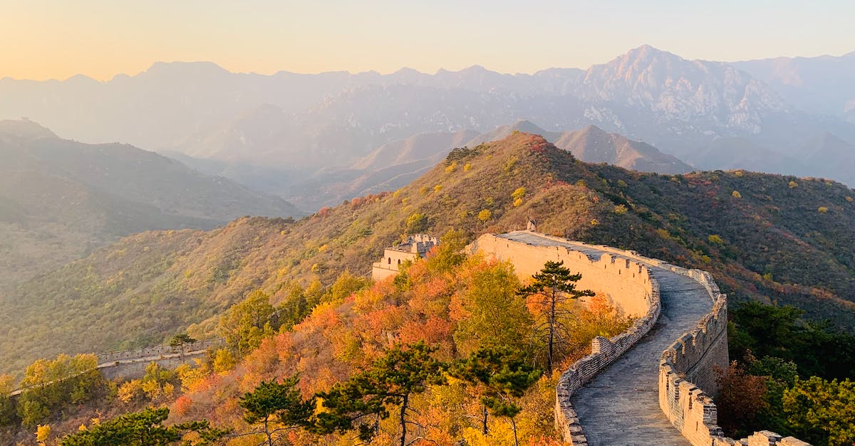 What part of Great Wall of China is easier to visit, starting from Peking? - Picturesque landscape of Great Wall of China on hill with green trees and mountains on background on sunny day